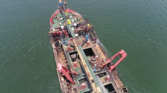 Aerial video of a dredging vessel operating offshore, showing the ship during maritime operations.