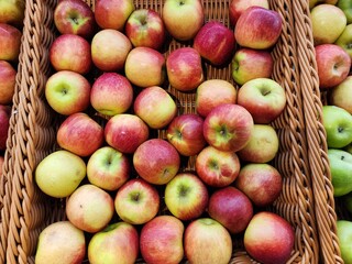 Fresh Apples Displayed in Wooden Baskets at a Market