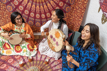 Women playing traditional instruments and drinking organic cocoa during ceremony