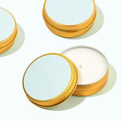 Aroma soy wax candles in a metal jar.Modern Colorful pattern with scented candles in a metal can.Mint candles for cozy atmosphere on light blue background.Trendy pastel colors. Wellness, spa concept