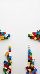Colorful building blocks scattered on a clean white surface, creating a playful and creative composition