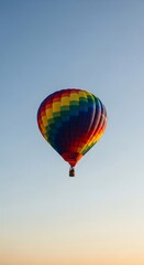 Fototapeta premium Colorful Hot Air Balloon Soaring Against a Pale Sky