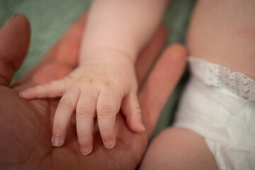 Baby's hand on daddy's hand