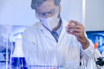 An Indian scientist working with scientific apparatus in a modern laboratory, conducting experiments and gathering data. Concept for scientific method and technological advancement.