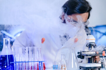 A dedicated Indian researcher analyzes a biological sample in a lab, contributing to medical...