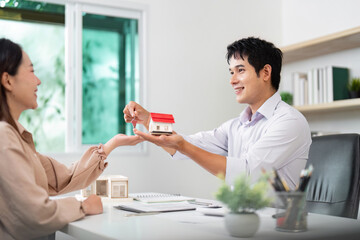 Real Estate Transaction. Agent handing over keys to a new homeowner.