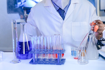 An Indian scientist working with scientific apparatus in a modern laboratory, conducting experiments and gathering data. Concept for scientific method and technological advancement.