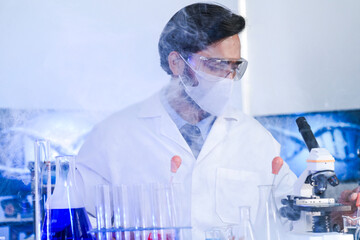 A dedicated Indian researcher analyzes a biological sample in a lab, contributing to medical...
