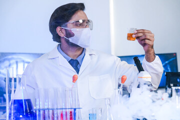 A dedicated Indian researcher analyzes a biological sample in a lab, contributing to medical...