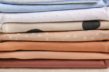 Stack of different baby clothes, closeup