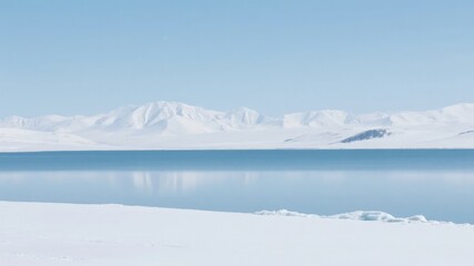 Fototapeta premium Snowy Landscape with Calm Waters and Distant Mountains