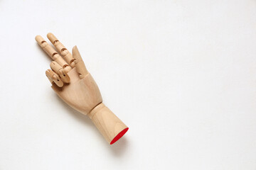 Wooden hand showing gun gesture on white background