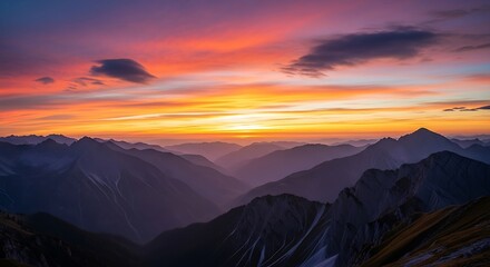 Majestic mountain range silhouetted against a vibrant and colorful sky at sunset