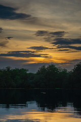 Sunset on river with trees