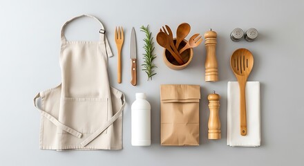 Flat lay of natural kitchen essentials including an apron herbs and wooden utensils for cooking