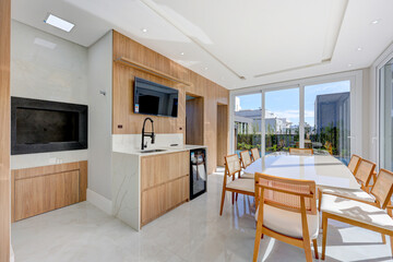 Bright Open-Plan Kitchen and Dining Area with Wooden Ceiling and Panoramic Outdoor View,
