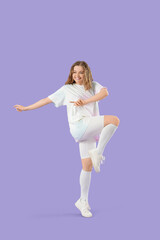 Obraz premium Cool young woman dancing on lilac background