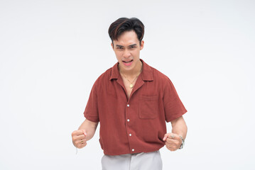 An enraged young Asian man screaming with fury, holding his fist out in a powerful burst of anger....