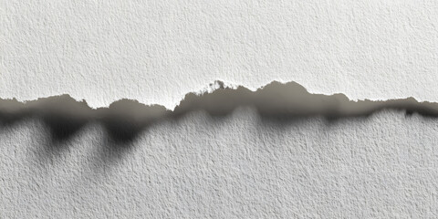 Torn edge of textured white paper sheet on a smooth light background with subtle shadows creating depth and dimension at the bottom edge.