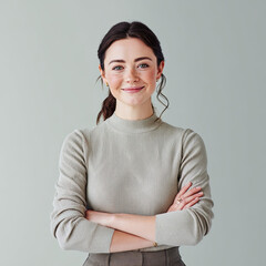 Confident young professional woman with warm, optimistic smile stands with arms crossed. Her empowered demeanor suggests visionary founder ready for business leadership in clean space