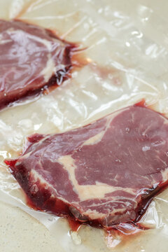 Vacuum-packed whole-cut ribeye steak during thawing