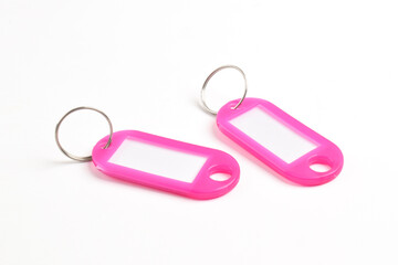 Pink plastic key tag isolated on white background