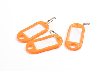 Orange plastic key tag isolated on white background