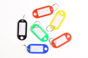 Colorful plastic key tag isolated on white background. Top view, Flat lay