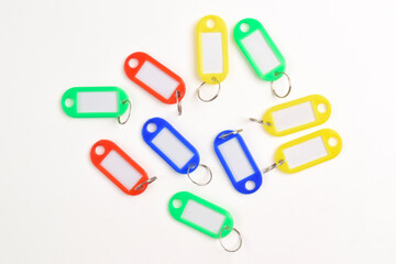 Colorful plastic key tag isolated on white background. Top view, Flat lay