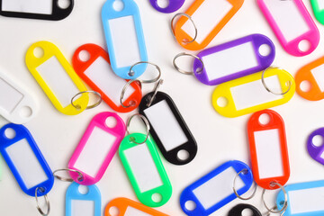Colorful plastic key tag isolated on white background. Top view, flay lay