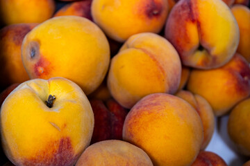 Fresh ripe peaches closeup at market.