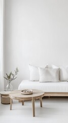 A minimalist living room with a round wooden table and white sofa against a white wall