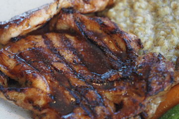 Delicious grilled chicken served with rice and mixed vegetables