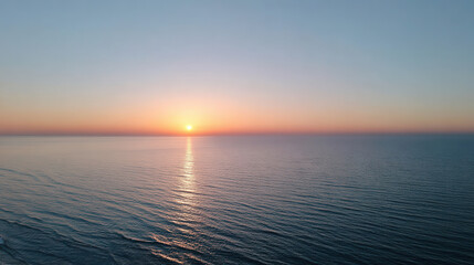 breathtaking aerial view of oceans surface at dawn showcasing smooth water reflecting suns rays