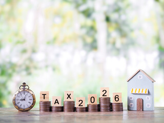 Vintage watch, Miniature house and stack of coins. The concept about saving money and manage time to payment tax for house, Property investment, House mortgage, Real estate in year 2026