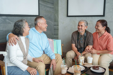 group of senior family and friends having meeting and take a break at cafe and  bakery before going travel together