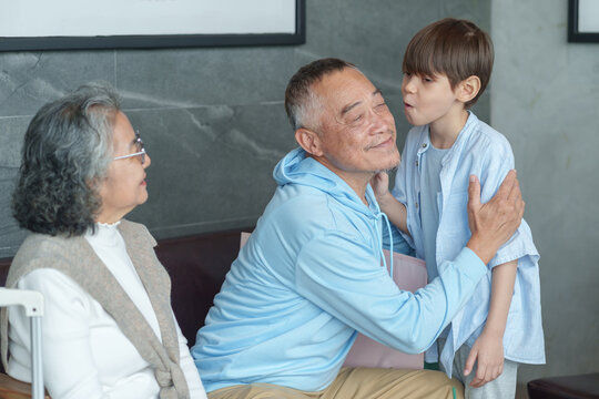 group of the generations family take a break coffee together at coffee shop,resting during travel,bonding grandson kiss on cheek grandfather
