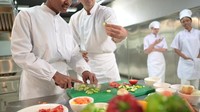 Modern kitchen equipped a head chef leads a diverse team of assistants. The chef, dressed in a crisp white uniform at a high-end restaurant working during prep time, focused energy, teamwork.