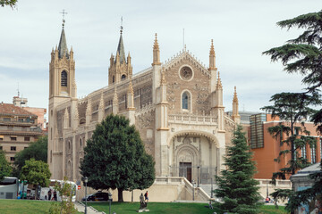 San Jeronimo El Real Church In Madrid With Gothic Facade And Green Park Area