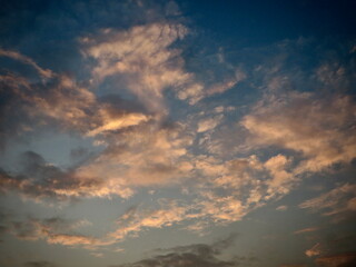 Fototapeta premium Dramatic Sunset Cloudscape: Golden Beams Slice Through a Moody Blue Sky in Tam Coc, Ninh Binh, Vietnam