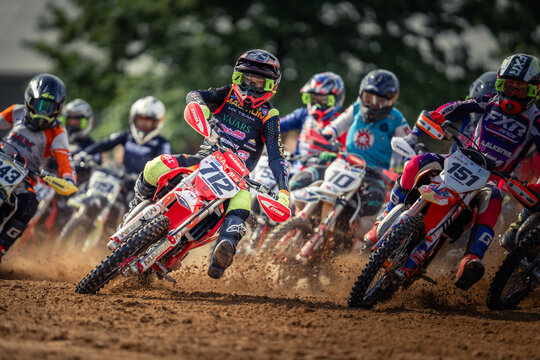 A group of motorcyclists racing on dirt bikes
