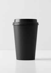 Black disposable coffee cup with black lid on white surface