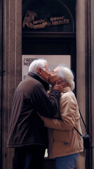 Elderly couple sharing a cinematic kiss