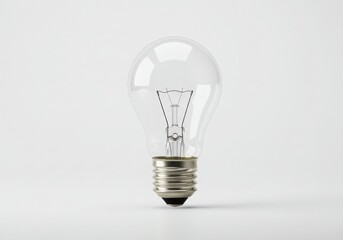 Clear incandescent light bulb with visible filament on white background
