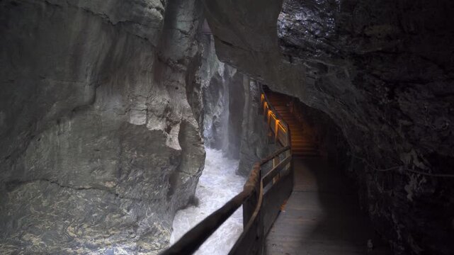Path through a gorge along a wild river.