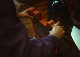 Mature man putting tools away 