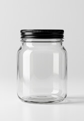 Clear glass mason jar with black lid on white background