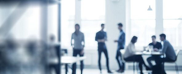 Group of people in a bright office setting having a meeting.