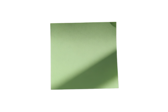 A light sage green sticky note, square, isolated on black.  Shadow falls diagonally across