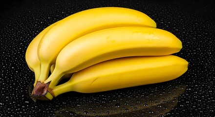 Yellow bananas on wet black surface fruit bunch